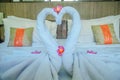 Honeymoon Bed Suite decorated with flowers and towels.The swan towels on the bed in a hotel room Royalty Free Stock Photo