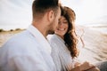 Honeymoon on a desert island. Young couple sitting on the beach and smiling Royalty Free Stock Photo