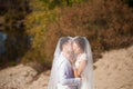 Honeymoon of just married wedding couple. happy bride, groom standing on beach, kissing, smiling, laughing, having fun on beach Royalty Free Stock Photo