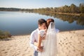 Honeymoon of just married wedding couple. happy bride, groom standing on beach, kissing, smiling, laughing, having fun on beach Royalty Free Stock Photo