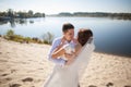 Honeymoon of just married wedding couple. happy bride, groom standing on beach, kissing, smiling, laughing, having fun on beach Royalty Free Stock Photo