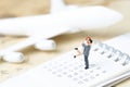 Honeymoon trip, wedding proposal, family travel tourism and vacation concept, miniature young couple standing on calendar with to