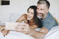 Honeymooners taking a selfie in bed Royalty Free Stock Photo