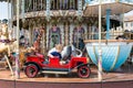 Caroussel harbor Honfleur with lovely little girl in red car