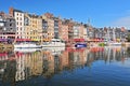 Honfleur harbour in Normandy France. Color houses and their reflection in water