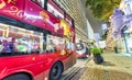 HONG KONG - APRIL 2014: Red buses along city streets at night. T Royalty Free Stock Photo