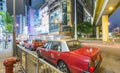 HONG KONG - APRIL 2014: Red taxis along city streets at night. T Royalty Free Stock Photo