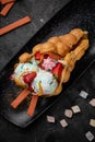 Hong Kong or bubble waffle with ice cream, fruits and colorful candies