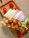 Hong Kong bubble waffles sandwich with ham, cheese and vegetables on wooden table Royalty Free Stock Photo