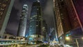 Hong Kong Business District timelapse at Night. Corporate building at the back and busy traffic across the main road at Royalty Free Stock Photo