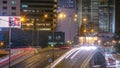 Hong Kong Business District timelapse at Night. Corporate building at the back and busy traffic across the main road at Royalty Free Stock Photo