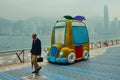 HONG KONG, CHINA - APRIL 29, 2014: An elderly Chinese man walks along the Avenue of Stars. Misty, sad weather on the embankment