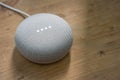 Hong Kong, China - 12 December, 2017:Google Home Mini Chalk color on a wooden surface