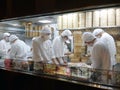 Chinese restaurant kitchen viewed through window from street. Men cooks cooking meals Royalty Free Stock Photo