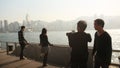 Hong Kong, China - January 1, 2016: People in the harbor of Victoria in Hong Kong. View of the sea and the city from the Royalty Free Stock Photo