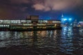 Night Star Ferry pier view in Tsim Sha Tsui in Hong Kong. Star Ferry boat on city skyline background Royalty Free Stock Photo