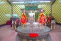 HONG KONG, CHINA - JANUARY 26, 2017: Tsz wan temple, with a hell representation, with an inciense over a table with some