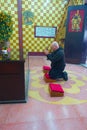 HONG KONG, CHINA - JANUARY 26, 2017: Unidentified man plraying inside of the Tsz wan temple, in Hong Kong, China