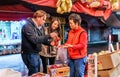Young couple buying fruit at Hong Kong outdoor food market in Tai Po. Night view