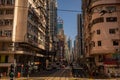 Central streets of Hong Kong. Taxis, buses, and trams go down the street Royalty Free Stock Photo