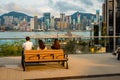 Hong Kong, China - People enjoying the view of the city harbour side