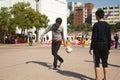 Chines teenagers playing football at public playground
