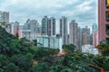 Hong Kong city private residential high-rise buildings in the evening. Scenic cloudy cityscape with green trees and skyscrapers Royalty Free Stock Photo