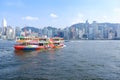 cityscape and ferry boat at Victoria Harbor in Hong Kong Royalty Free Stock Photo