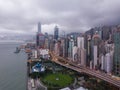 Hong Kong Downtown with clouds in storm. Dramatic sky with raining in Victoria Harbour. Financial district and business centers. Royalty Free Stock Photo