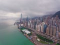 Hong Kong Downtown with clouds in storm. Dramatic sky with raining in Victoria Harbour. Financial district and business centers. Royalty Free Stock Photo