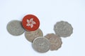 Hong Kong flag on the coin with heap of Hong Kong dollar coin money on white background. Concept of finance