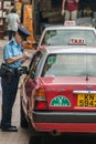 Traffic warden writes a car up for infraction on Hong Kong Island China Royalty Free Stock Photo