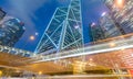 HONG KONG - MAY 12, 2014: Downtown skyscrapers with road car light trails at night. Hong Kong attracts 25 million people annually Royalty Free Stock Photo