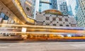 HONG KONG - MAY 12, 2014: Downtown skyscrapers with road car light trails at night. Hong Kong attracts 25 million people annually Royalty Free Stock Photo