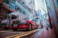 HONG KONG - May 19, 2023: A red taxi at a traffic light in Hong Kong. Low angle view Royalty Free Stock Photo