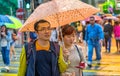 HONG KONG - MAY 8, 2014: Tourists and locals walk akong city streets on a rainy night Royalty Free Stock Photo