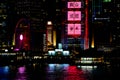 Hong Kong at night. Central pier, ferris wheel, colorful advertising, chinese ideographs, beautiful reflections Royalty Free Stock Photo