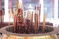 Hong Kong : November 20, 2019 - Closeup group of incenses put in the brass ashtray with smoke in the air at Wong Ta Sin temple