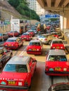 Red city taxis in road traffic, Hong Kong