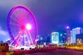 Hong Kong Observation Wheel against skyscrapers and modern buildings near central pier. Long exposure abstract night image Royalty Free Stock Photo