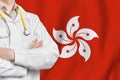 Hong Kong Special Administrative Region of the People`s Republic of China healthcare concept with doctor on HKSAR flag background