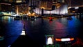 Hong Kong Victoria harbour and its iconic red ancient junk sail zoom shot from the Peak at night