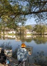 Hongcun Ancient Town in Anhui Province, China. An artist stands by Nanhu Lake painting the buildings and trees