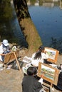 Hongcun Ancient Town in Anhui Province, China. Artists sit by Nanhu Lake painting the buildings and trees