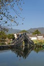 Hongcun Ancient Town in Anhui Province, China. The stone bridge crossing Nanhu Lake with people taking photographs