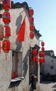 Hongcun Ancient Town in Anhui Province, China. Traditional building with red lanterns, Chinese flag and shopkeeper Royalty Free Stock Photo