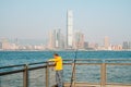 Fisher man with fishing rod on coast with HongKong skyline