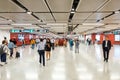 People walking inside Central MTR station / underground subway train station in HongKong