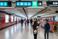 People walking inside Central MTR station / underground subway train station in HongKong