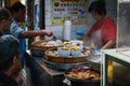 People buying Chinese street food in Hong Kong